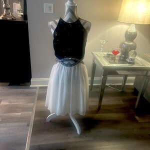Beautiful cocktail dress, black & White, with cutouts on the sudes.